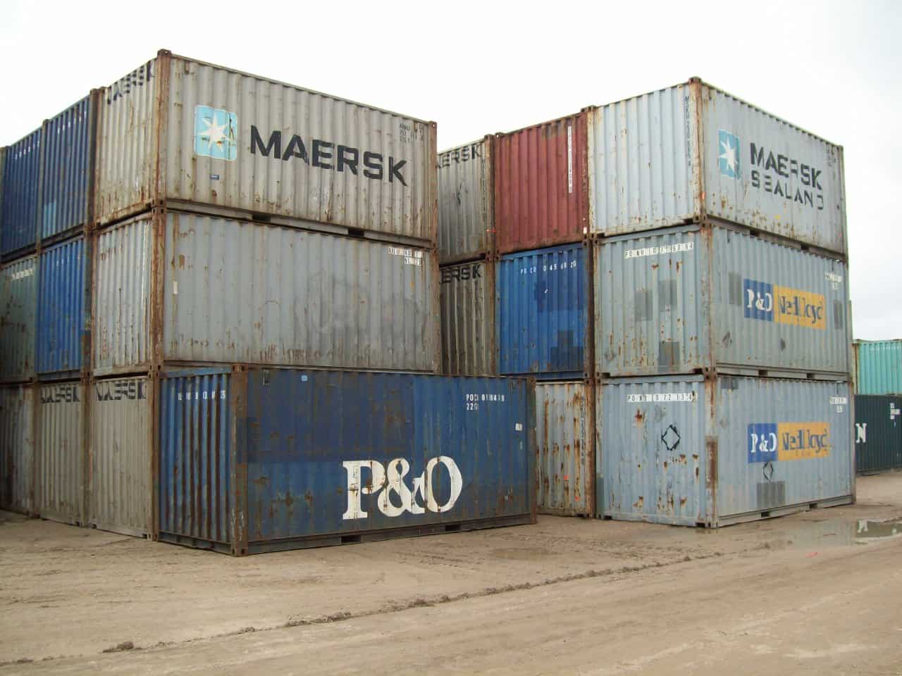 Used shipping containers stacked two and three high in a container yard