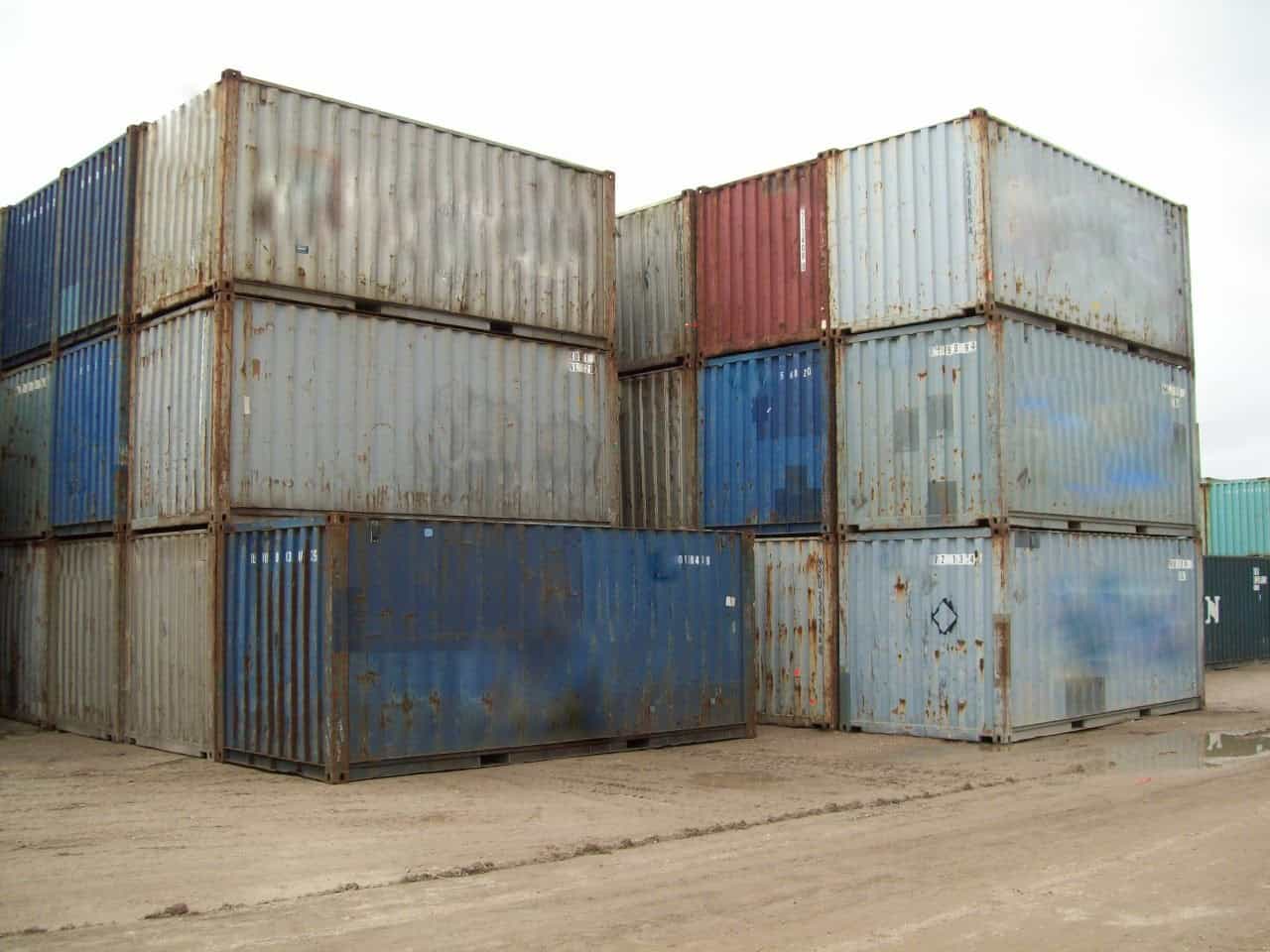 Stacked 20ft shipping containers in a depot yard