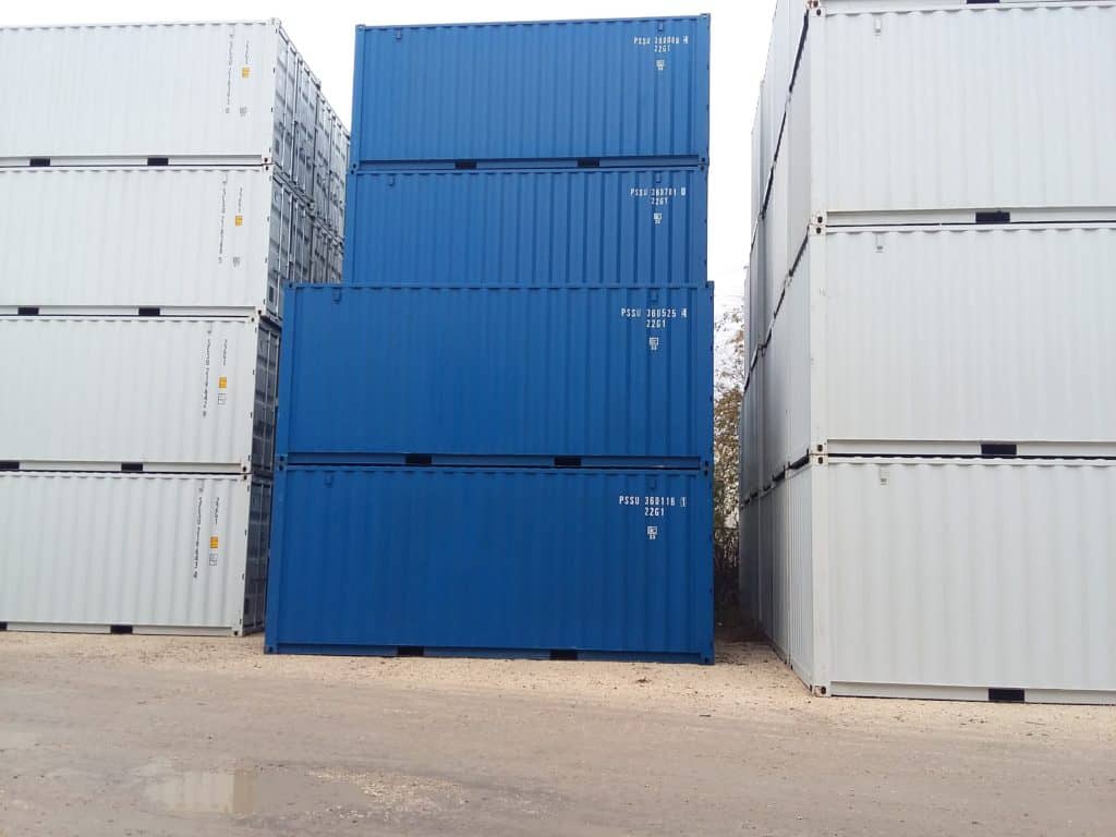Stacks of blue 20ft containers between rows of white containers