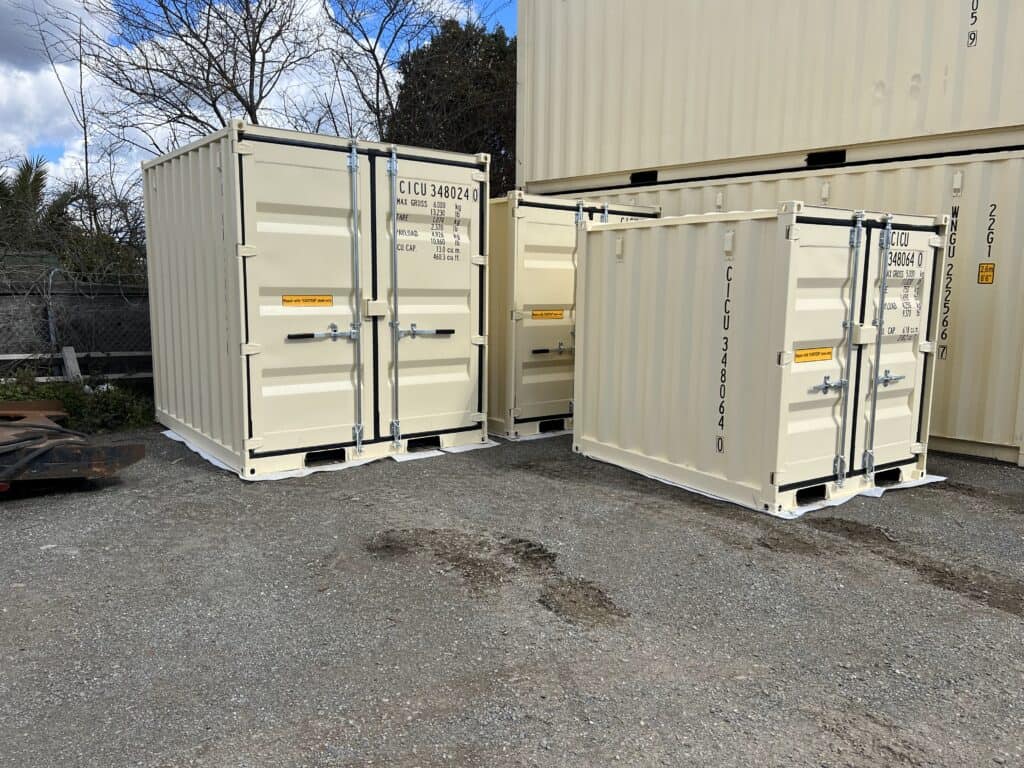 New beige 10ft and 20ft containers in a depot yard