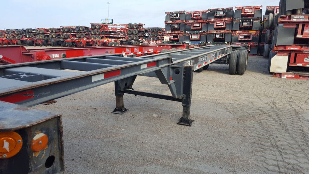 Red 40ft container chassis in a chassis yard