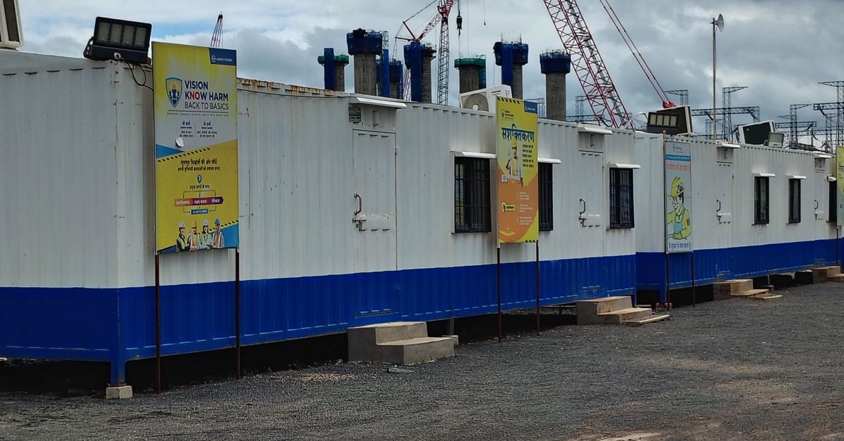 Row of white and blue modular container offices on a construction site