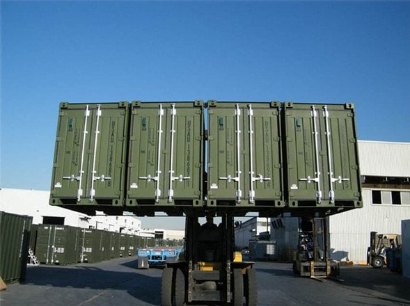 Forklift lifting four coupled quadcon containers as a single 20ft unit